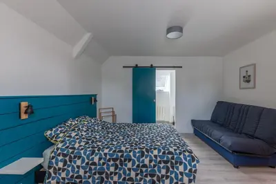 Un ou plusieurs lits dans un hébergement de l'établissement Gîte du Tilleul - Maison climatisée pour 8 voyageurs