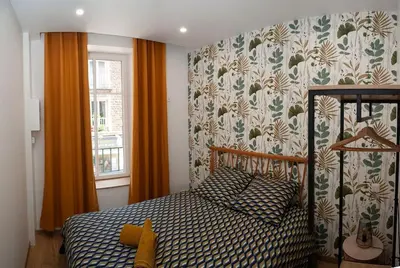 Un ou plusieurs lits dans un hébergement de l'établissement Joli appartement F2 plein centre Coutances