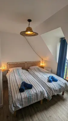 Un ou plusieurs lits dans un hébergement de l'établissement Cottage Cabourg plage avec jardin et vélos