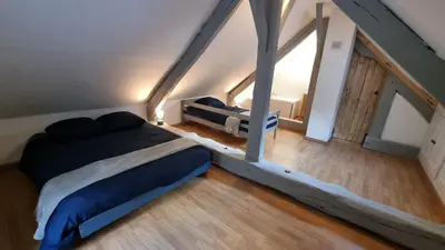 Un ou plusieurs lits dans un hébergement de l'établissement Maison au cœur des Bois