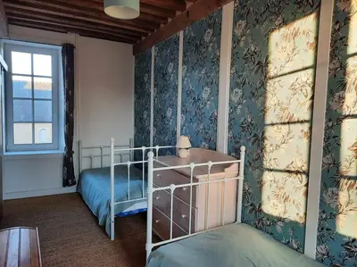 Un ou plusieurs lits dans un hébergement de l'établissement Gîte du Manoir