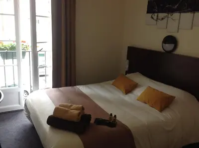 Un ou plusieurs lits dans un hébergement de l'établissement Hotel de la Paix