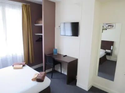 Un ou plusieurs lits dans un hébergement de l'établissement Hotel de la Paix