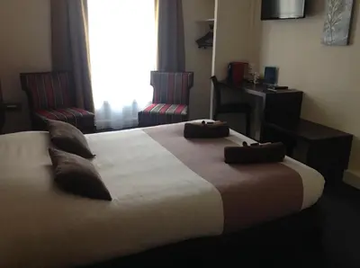 Un ou plusieurs lits dans un hébergement de l'établissement Hotel de la Paix