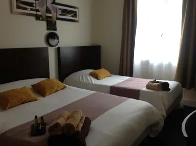 Un ou plusieurs lits dans un hébergement de l'établissement Hotel de la Paix