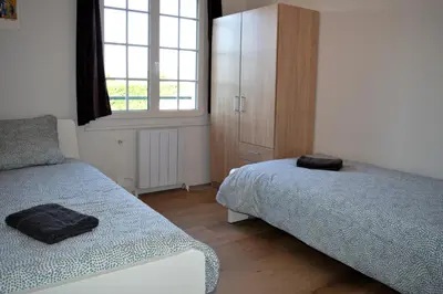 Un ou plusieurs lits dans un hébergement de l'établissement Les 7 lutins - Maison avec jardin, wifi, parking