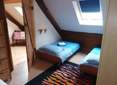 Un ou plusieurs lits dans un hébergement de l'établissement Le Moulin des Hiboux - Gite avec salle de jeux games room
