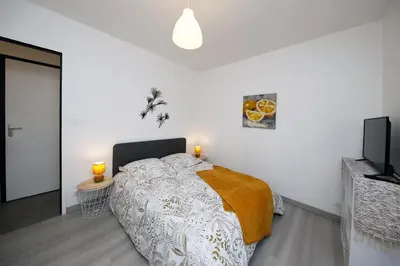 Un ou plusieurs lits dans un hébergement de l'établissement L'Océraline - Maison avec jardin et wifi