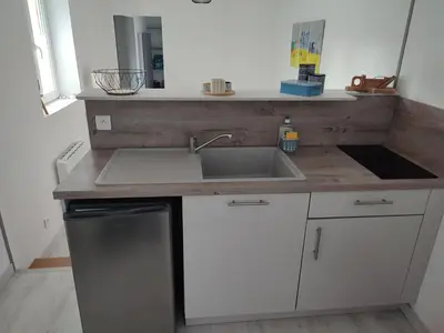 Cuisine ou kitchenette dans l'établissement le Cozy Bayeusain