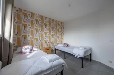 Un ou plusieurs lits dans un hébergement de l'établissement Villa Elaïa maison Familiale Omaha Beach