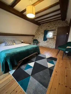 Un ou plusieurs lits dans un hébergement de l'établissement Gîte de la petite tour