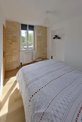 Un ou plusieurs lits dans un hébergement de l'établissement Logement cosy parking privé situé au cœur du village
