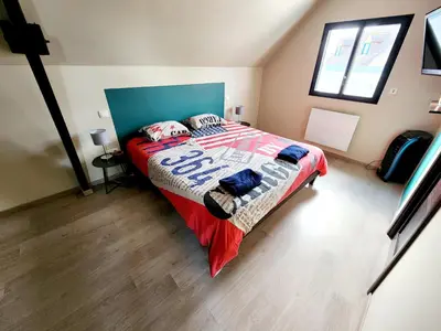Un ou plusieurs lits dans un hébergement de l'établissement Maison spacieuse 4 chambres