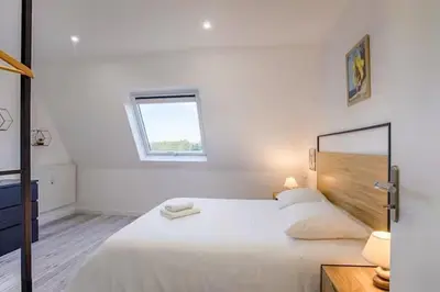 Un ou plusieurs lits dans un hébergement de l'établissement Bel Appartement Cabourg