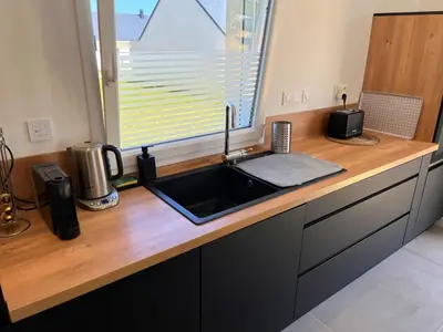 Cuisine ou kitchenette dans l'établissement Maison neuve proche plage avec parking gratuit