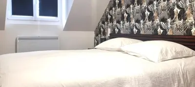 Un ou plusieurs lits dans un hébergement de l'établissement La maison GUILLAUME