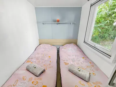 Un ou plusieurs lits dans un hébergement de l'établissement Mobile Home Eden