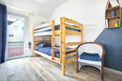 Un ou plusieurs lits dans un hébergement de l'établissement Le Poulpe Bleu - Maison 6p avec jardin