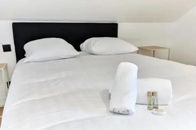 Un ou plusieurs lits dans un hébergement de l'établissement Appartement Lumière Normande - Welkeys