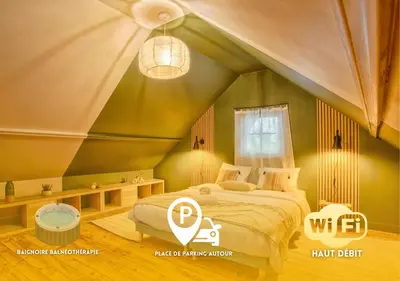 Un ou plusieurs lits dans un hébergement de l'établissement Maisonnette relaxante, balnéo & confort, proche de la gare