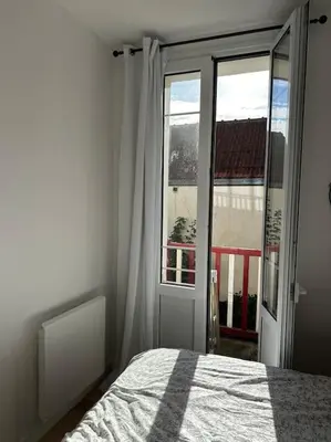 Un ou plusieurs lits dans un hébergement de l'établissement Charmante maison Cabourgeaise