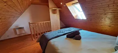 Un ou plusieurs lits dans un hébergement de l'établissement Cottage La Chaumière