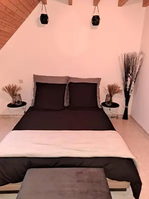 Un ou plusieurs lits dans un hébergement de l'établissement Cottage La Chaumière