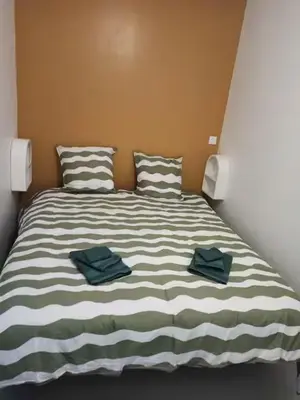 Un ou plusieurs lits dans un hébergement de l'établissement Appartement 2 à 4 personnes proche de la mer