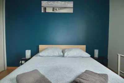Un ou plusieurs lits dans un hébergement de l'établissement Loubapa, appartement en rez-de-jardin