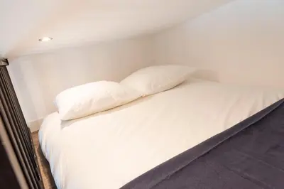 Un ou plusieurs lits dans un hébergement de l'établissement Appartement proche Place Saint-Sauveur