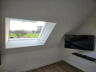 Télévision ou salle de divertissement dans l'établissement Appartement Granville 5