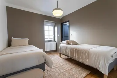 Un ou plusieurs lits dans un hébergement de l'établissement Appartement historique Dior