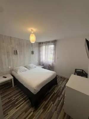 Un ou plusieurs lits dans un hébergement de l'établissement Maison du manoir