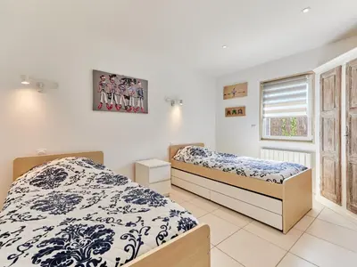 Un ou plusieurs lits dans un hébergement de l'établissement Holiday Home Chez Boubou by Interhome
