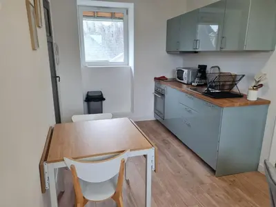 Cuisine ou kitchenette dans l'établissement Le Bayeusain
