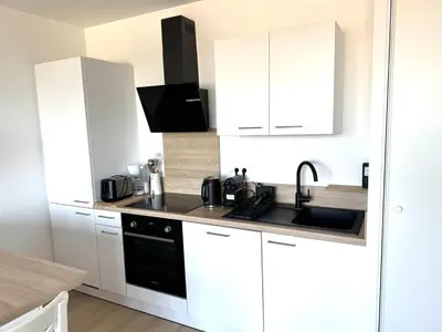 Cuisine ou kitchenette dans l'établissement Appartement Le Riva B304