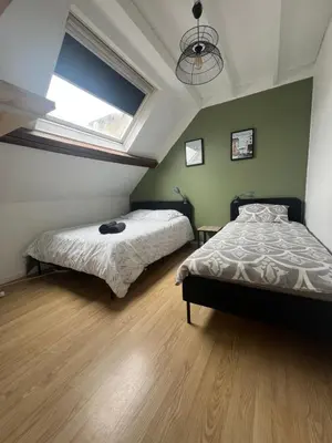Un ou plusieurs lits dans un hébergement de l'établissement WingFlat Appartement Entier Centre Ville Proche Naval Cité de la mer Quartier Calme