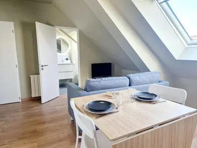 Télévision ou salle de divertissement dans l'établissement L'Ermitage Scandi