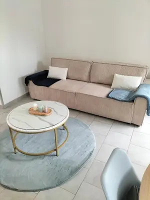 Coin salon dans l'établissement Appartement avec cour privée
