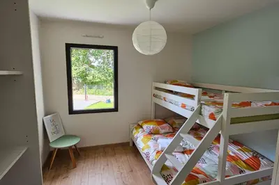 Un ou plusieurs lits dans un hébergement de l'établissement Charmante maison neuve