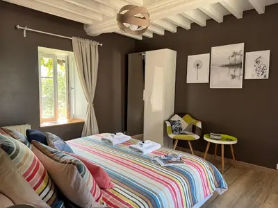 Un ou plusieurs lits dans un hébergement de l'établissement Chambre Le Mas du Bessin