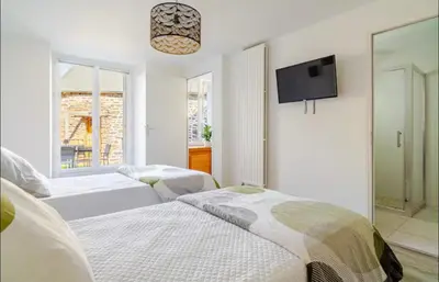 Un ou plusieurs lits dans un hébergement de l'établissement Le Cozy Maupas