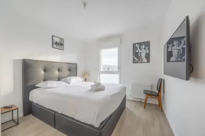 Un ou plusieurs lits dans un hébergement de l'établissement Appartement Tulipe - Welkeys