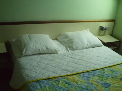 Un ou plusieurs lits dans un hébergement de l'établissement Hôtel l'Eden