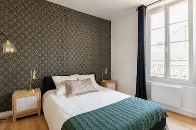 Un ou plusieurs lits dans un hébergement de l'établissement Appartement moderne au coeur du quartier historique