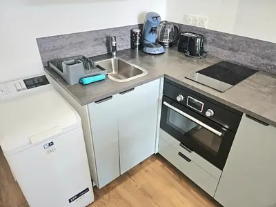 Cuisine ou kitchenette dans l'établissement Appartement Granville1