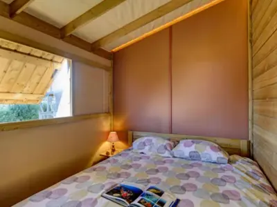 Un ou plusieurs lits dans un hébergement de l'établissement Tente en toile et bois avec terrasse pour 4 personnes - API-1-52-1471
