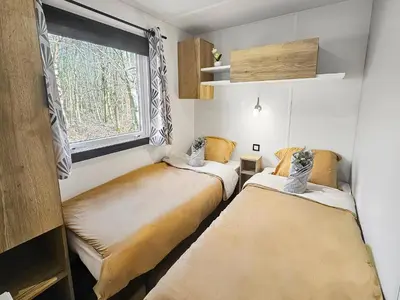 Un ou plusieurs lits dans un hébergement de l'établissement Mobil home 8 personnes Confort & Tranquillité