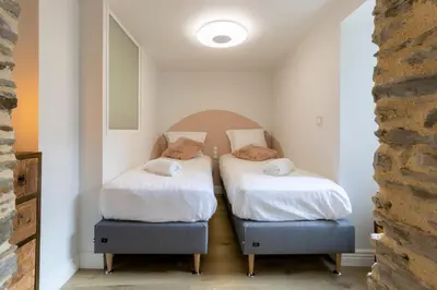 Un ou plusieurs lits dans un hébergement de l'établissement Maison de Pêcheur à Cancale, Jardin et Sauna - Le Jardin Suspendu