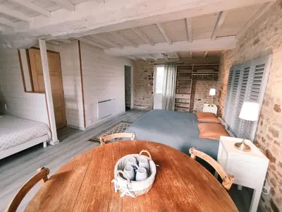 Un ou plusieurs lits dans un hébergement de l'établissement Omaha Secret Normandy Cottages